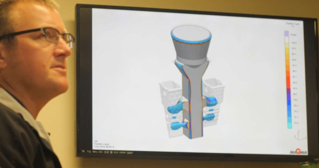 Presenter discussing a design of a part on screen